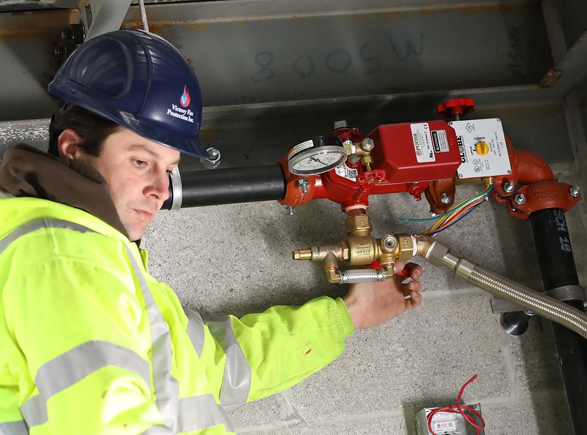 commercial-fire-sprinkler-contractor-valve-JB5D6397 Commercial fire sprinkler contractor inspecting valve for commercial fire sprinkler system repair